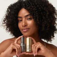Woman with curly hair holding Plated Hair Serum and Intense Serum