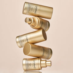 Plated Intense Serum bottles in gold packaging stacked and floating