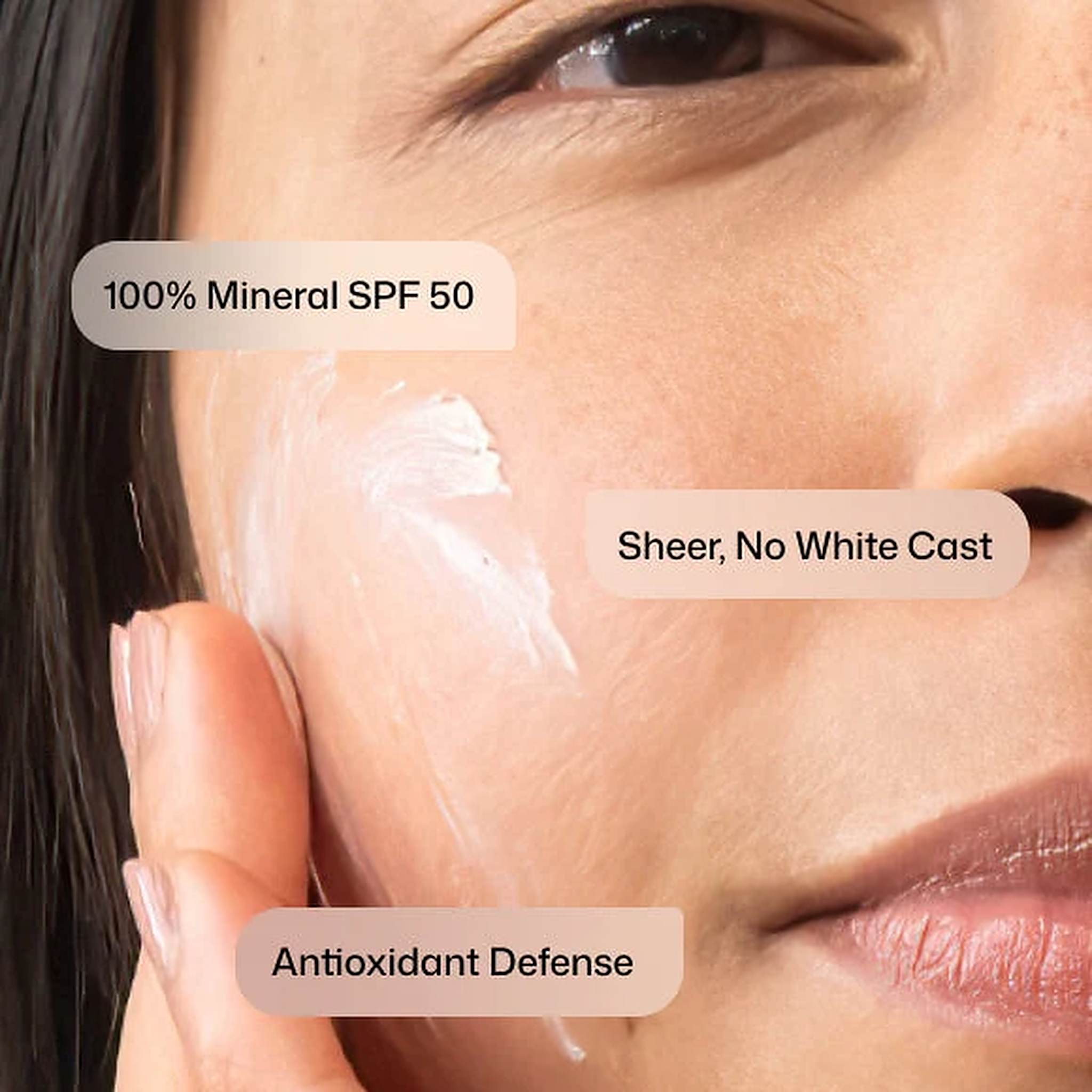 Woman applying Revision Skincare Intellishade TruPhysical Clear 100% mineral SPF 50 sheer with no white cast (108)