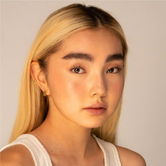 Model with fair skin wearing warm bronzer glow on cheeks