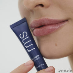 Close up of lips wearing Lipnights in Sleepover shade with tube in hand