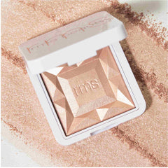 RMS Beauty ReDimension Hydra Dew compact with loose shimmer powder scattered around 3