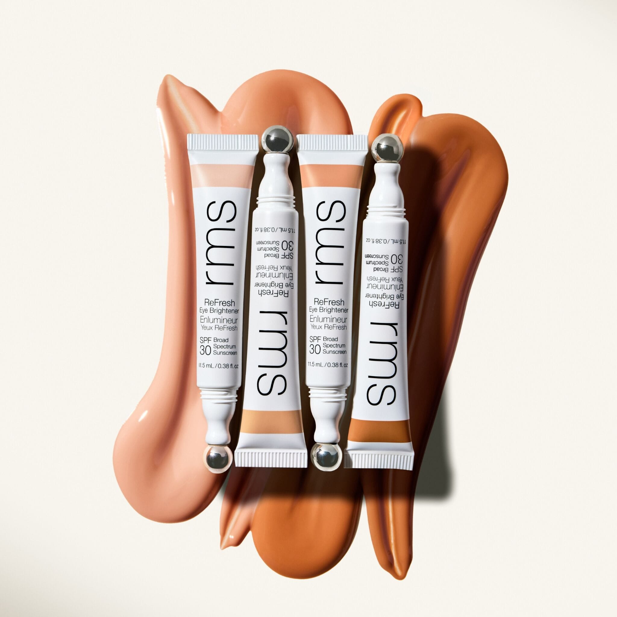 Two ReFresh Eye Brightener tubes styled with cream swatches 14