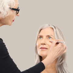 Makeup artist applying concealer under the eye with Skin2Skin Concealer Brush