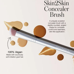 Skin2Skin Concealer Brush shown angled among swatched concealer drops