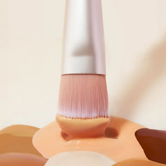 Close up of Skin2Skin Everything Brush bristles dipped in liquid foundation swatches