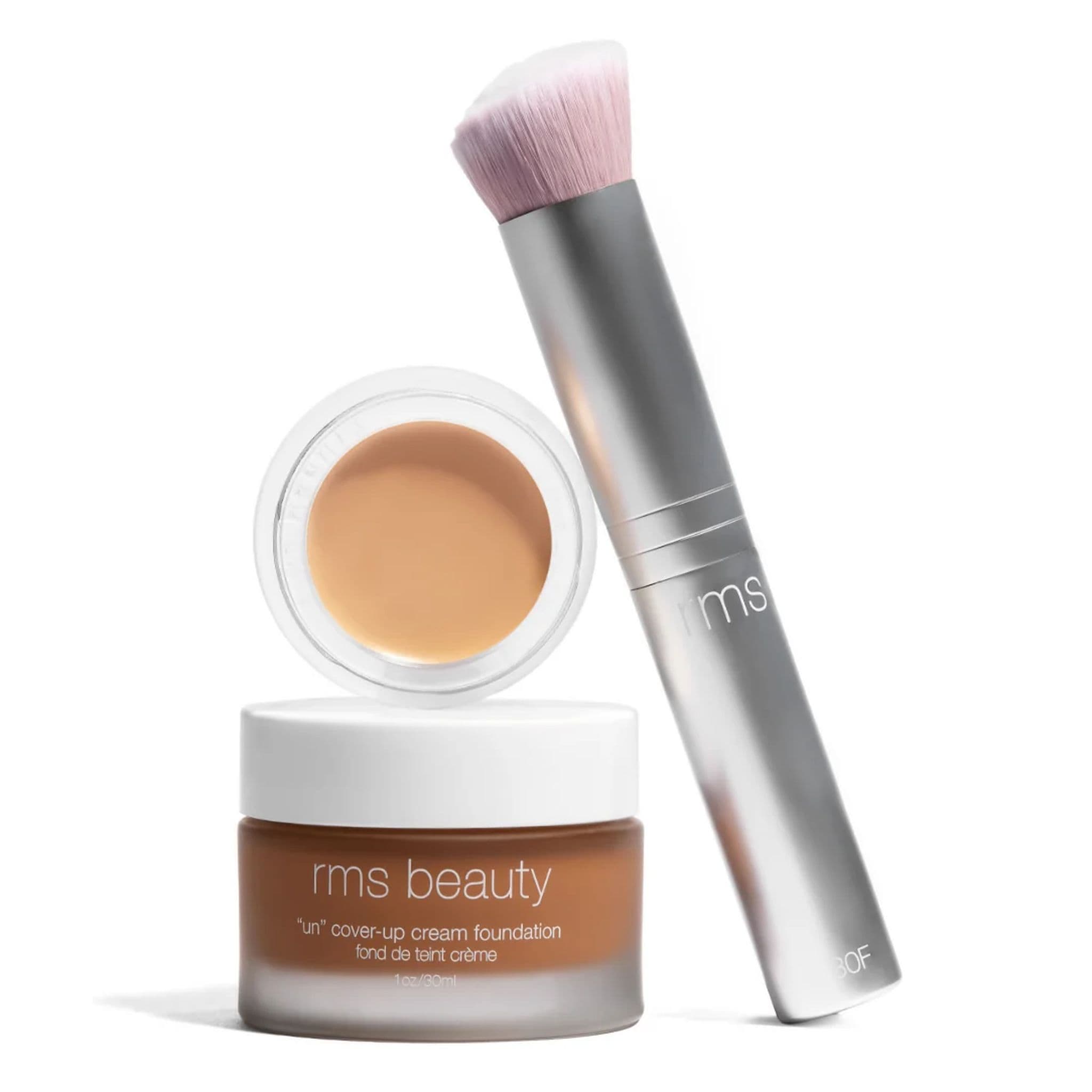 Skin2Skin foundation brush standing beside RMS Beauty Un Cover-Up cream foundation jar