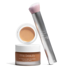 Skin2Skin foundation brush standing beside RMS Beauty Un Cover-Up cream foundation jar
