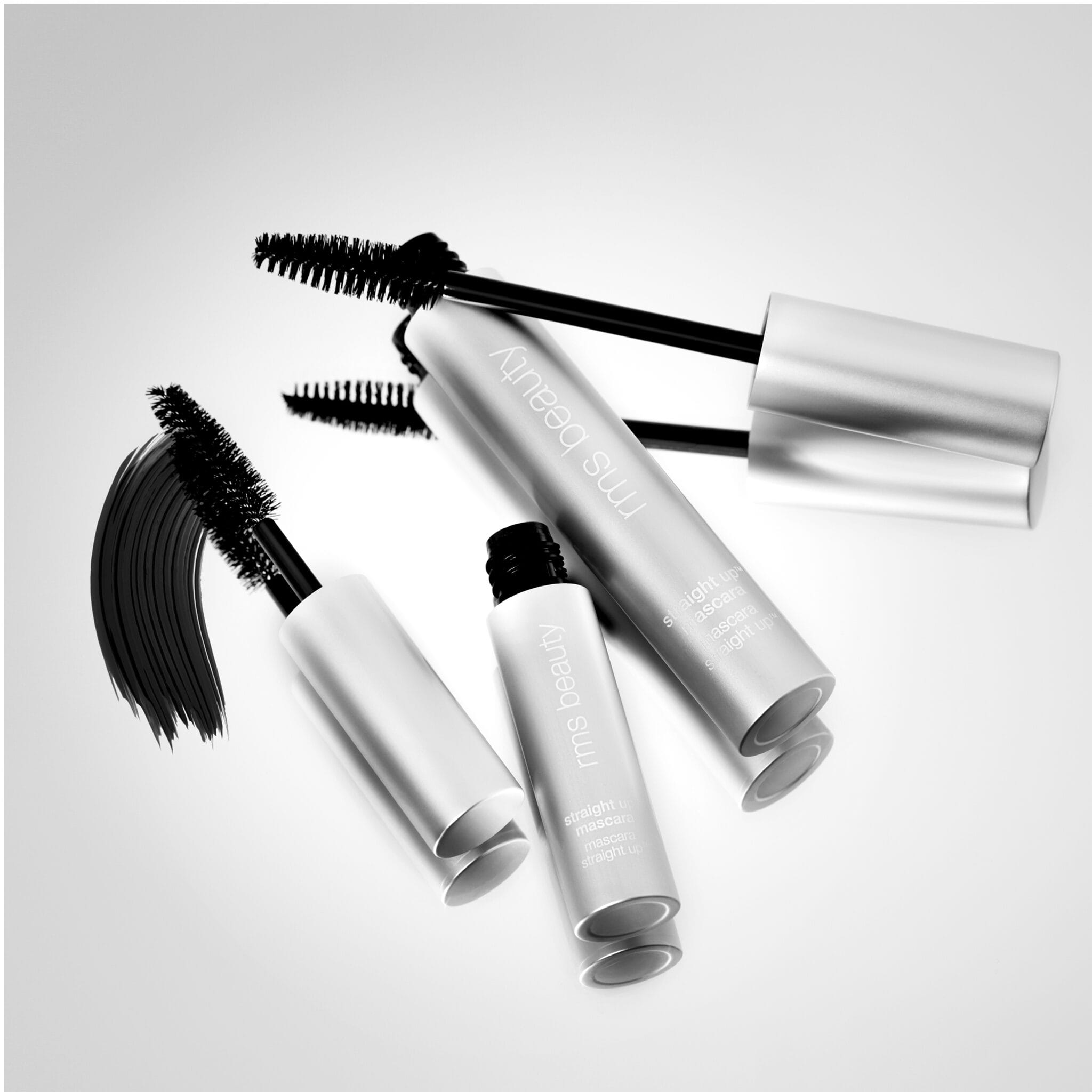Straight Up mascara tubes and wands shown in black and white styling