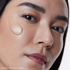 RMS Beauty SuperNatural Radiance Serum Medium Aura swatch on model's cheek 6