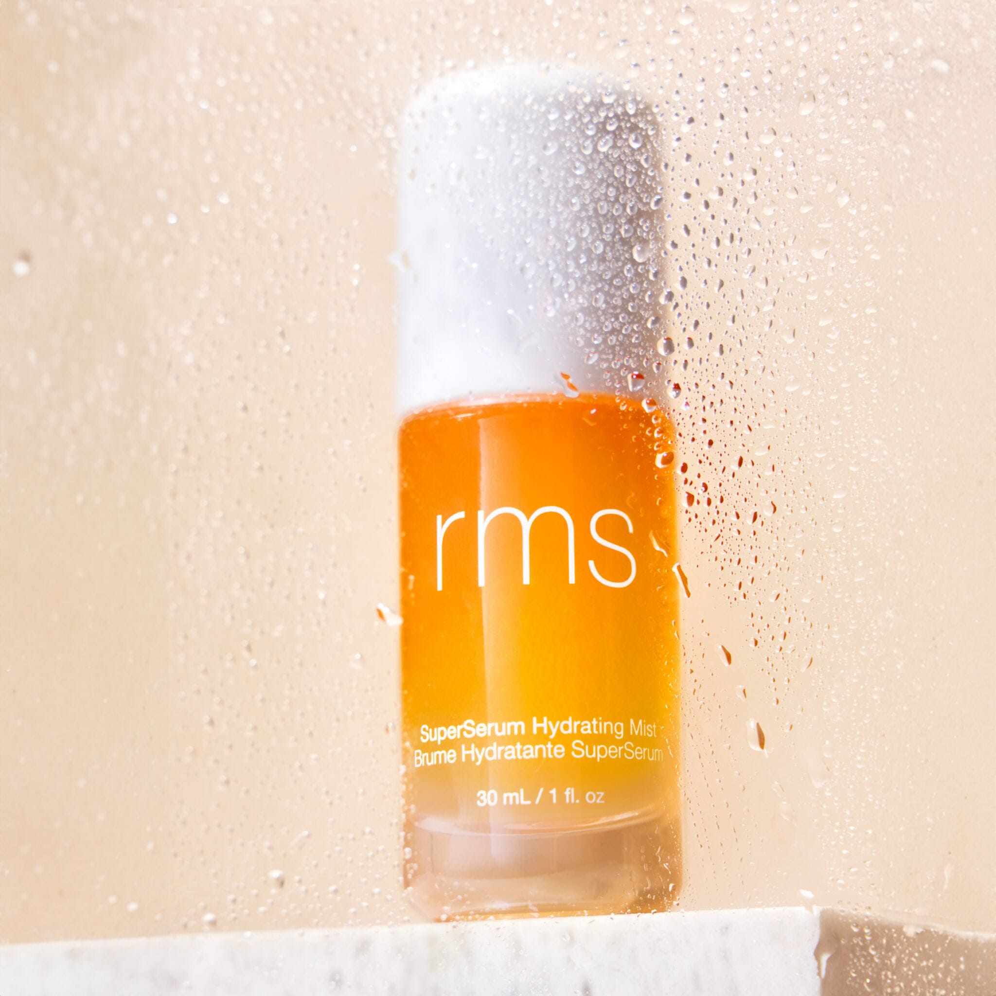 SuperSerum mist bottle close up with water droplets on glass