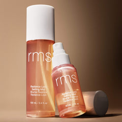 RMS Beauty Radiance Lock Setting Mist in 100ml and 30ml travel size bottles side by side