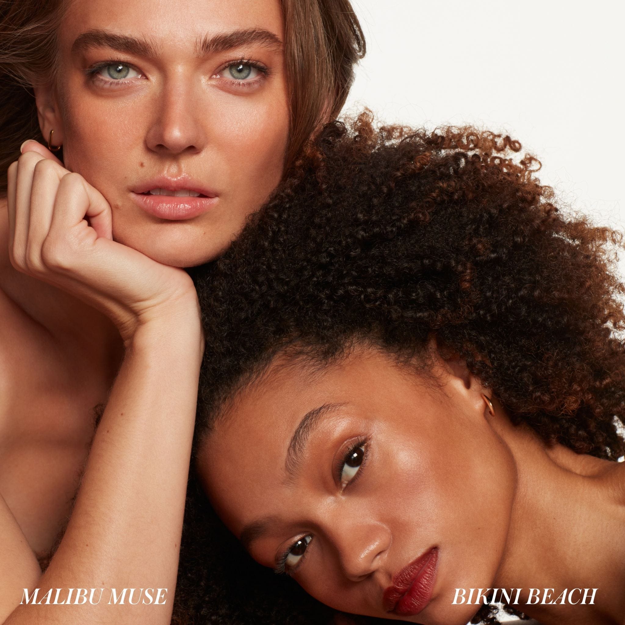 Two models wearing RMS ReDimension Hydra Bronzer in Malibu Muse and Bikini Beach 7