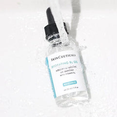 SkinCeuticals Hydrating B5 Gel 30ml bottle surrounded by water splash, moisture-enhancing serum with vitamin B5
