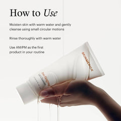 Hand holding SkinMedica Pore Purifying Gel Cleanser tube under water showing how to use morning and night
