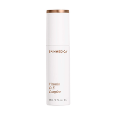 SkinMedica Vitamin C+E Complex old silver bottle next to new white and rose gold packaging