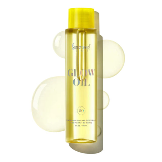 Supergoop Glow Oil SPF 50 body oil bottle with glowing oil droplets