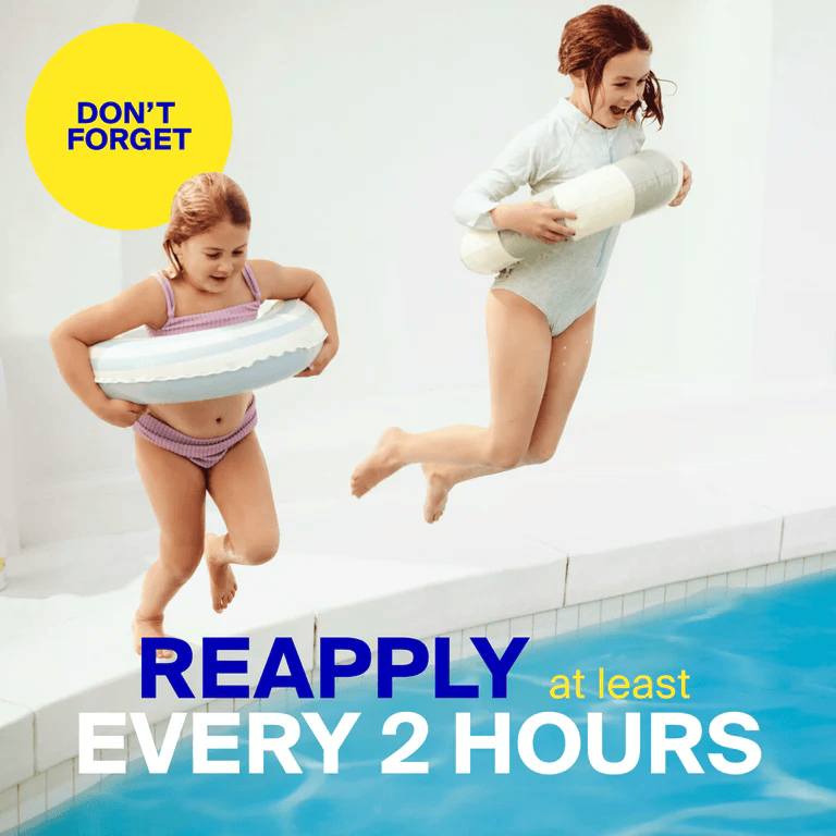 Kids jumping into a pool with a reminder to reapply sunscreen every two hours