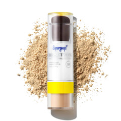 Supergoop Resetting 100% Mineral Powder SPF 35 stick in shade Light surrounded by loose powder