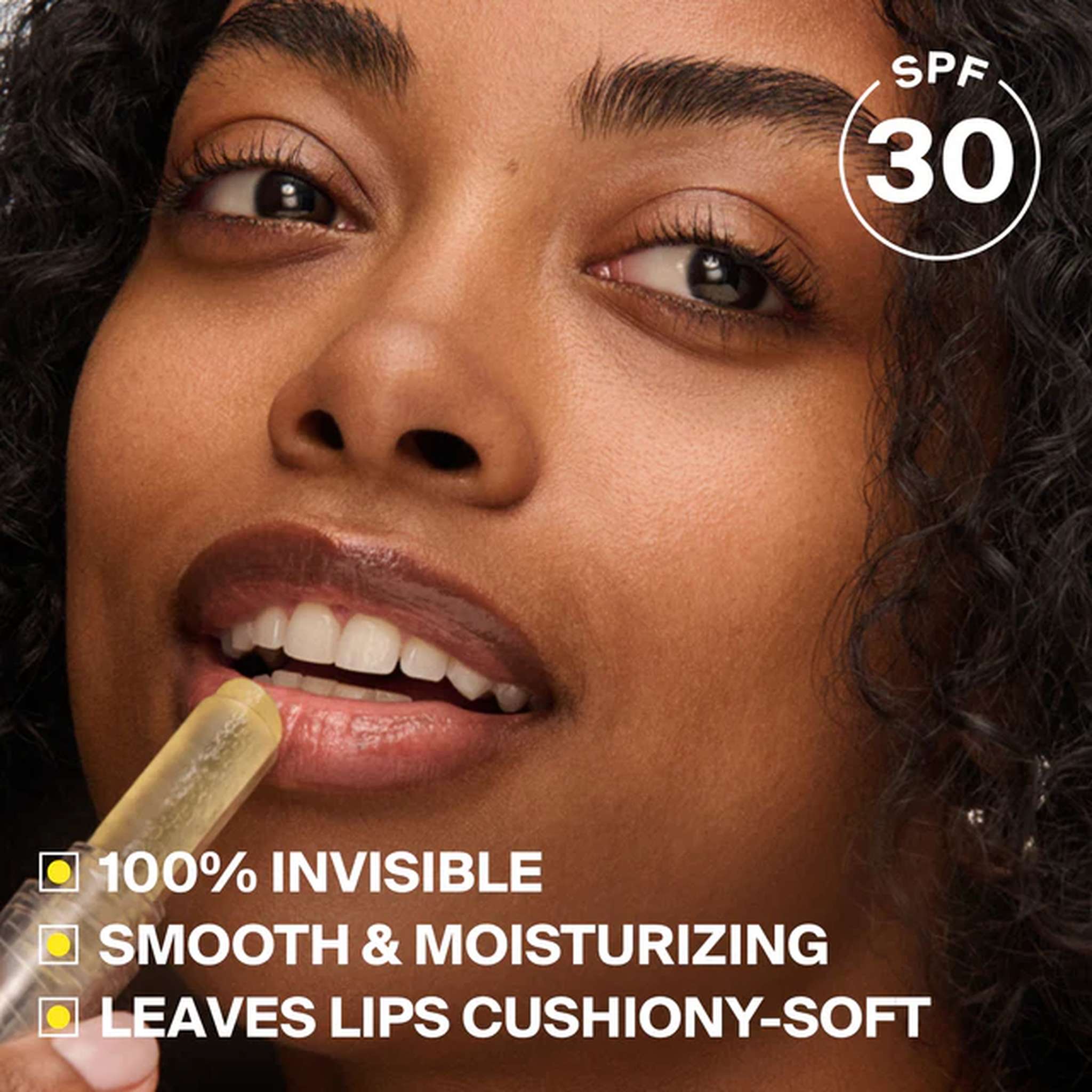 Woman applying Unseen Sunscreen Lip Balm SPF 30 with an invisible smooth moisturizing finish