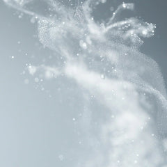 Fine mist spray burst on soft gray background showing the lightweight rejuvenating texture of Symbiome The Essence