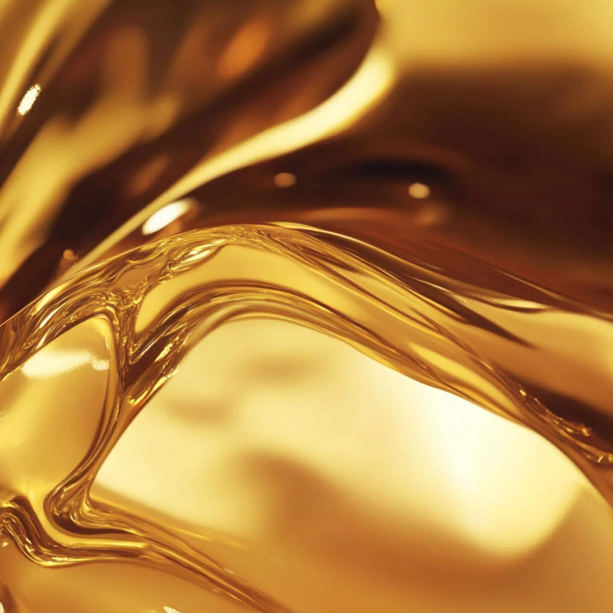 Close-up of rich golden body oil flowing in smooth fluid waves for Symbiome The Premise