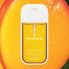 Touchland Power Essence Mango Mojo fragrance mist on a juicy ripe mango