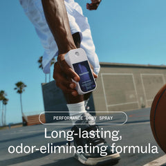 Basketball player holding Touchland Power Essence performance body spray with long-lasting odor-eliminating formula