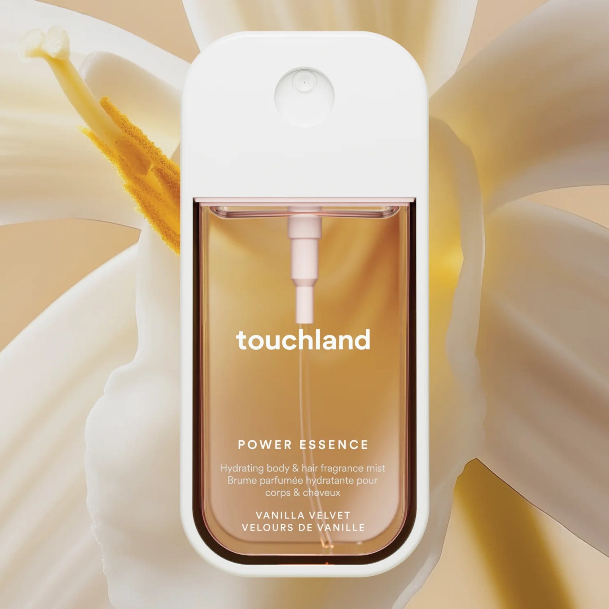 Touchland Power Essence Vanilla Velvet fragrance mist in front of a creamy vanilla orchid bloom