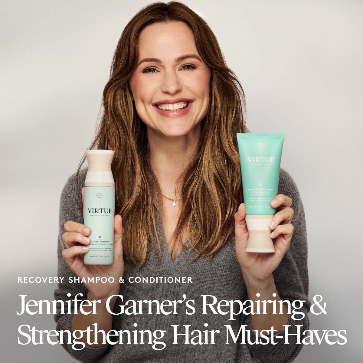 Jennifer Garner holding Virtue Recovery Shampoo and Recovery Conditioner for repairing and strengthening hair