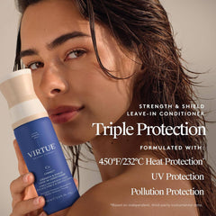 Model holding VIRTUE Leave-In Conditioner with 450°F heat UV and pollution protection