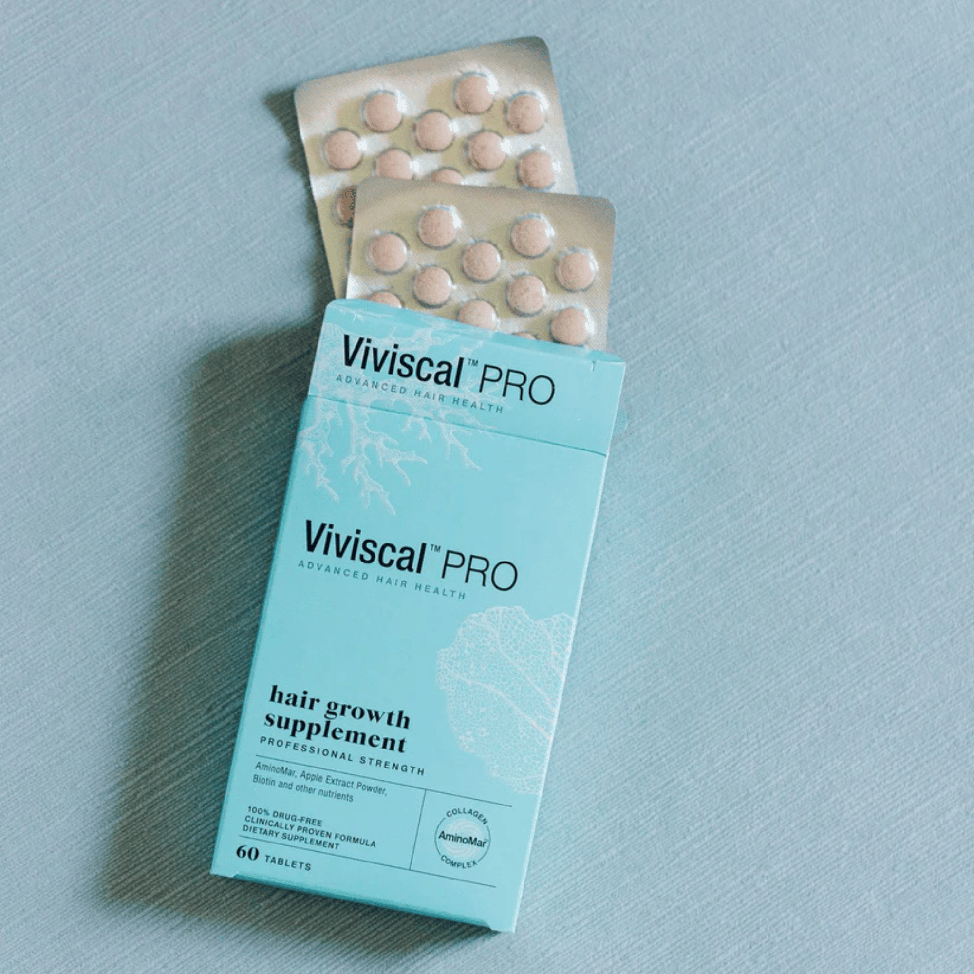 Viviscal Pro hair growth supplement packaging on a light blue background