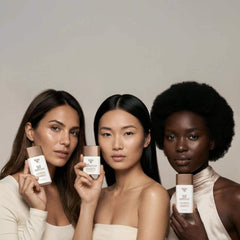 Three women holding Yon-Ka Paris SPF 50 Mineral Fluid broad spectrum sunscreen